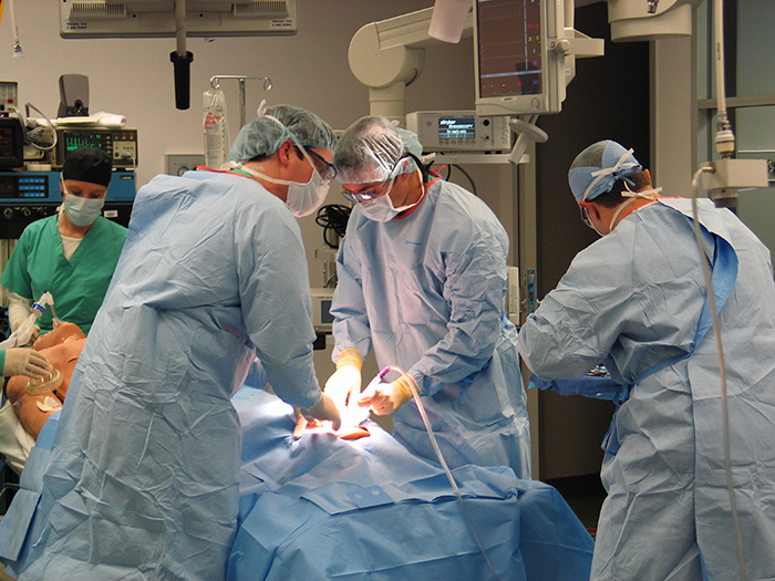 students performing a procedure in LSU Health New Orleans Simulation Education room